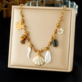 Brown woven rope necklace with golden shell, starfish, and pearl charms displayed on a box - Maple Leaf Flower Horn Pearl Pendant Style (N3682)