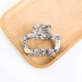 Gray marble patterned hair claw clip made of acetate on a wooden tray background - Grey Black Marble