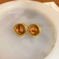 Close-up of vintage golden spiral earrings with amber resin marble texture on white plate - 26# Silver Earring Post-Gold-Brown-Spiral Round
