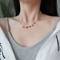 Rose gold flower necklace with delicate cherry blossom pendants on model - Necklace / Rose Gold