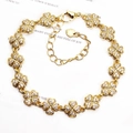 Detail of golden four-leaf clover bracelet featuring micro-paved white zircon stones - Pave Four Leaf Clover / Gold