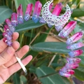 Pink and blue crystal crown with a hollow silver moon charm held over green foliage - Navy Blue and Red