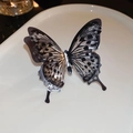 Macro detail of vintage acrylic butterfly ring featuring layered wings and glitter - Large Butterfly Open Style