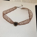 Detail view of brown lace choker necklace with heart-shaped pendant and pearl edging - Gold Heart Style