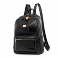 Minimalist black leather backpack for women featuring patchwork design and golden zippers - Black