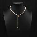 Natural freshwater pearl necklace with gold heart pendant and long tassel on a black bust - Heart Zirconia Shell Tassel Necklace