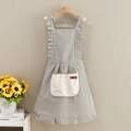 Detail of grey striped apron with beige pocket and brown label on a wooden hanger - Striped Princess Style-Towel Pocket Gray