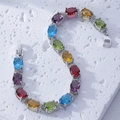 Close-up of multicolor zircon bracelet with oval-cut stones on white stone texture - Oval Multicolor Style (B00331) / Colorful Gemstones