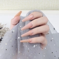 Glossy gradient nude pink long coffin press-on nails shown on model hand with ring - Gradient Nude Pink (CBLL-12)