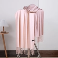 Detail of pink gradient cashmere scarf showing fringes and authentic material tag - No.24 Ivory Pink