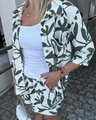 Detail of summer fashion set with green leaf print shirt and matching high waist shorts - S / Green