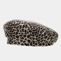 Detailed view of the glossy leopard print pattern on a faux leather beret hat - Beret / Beige