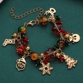 Christmas charm bracelet with Santa, snowflake and reindeer charms on gold chain - Pentagram Beaded Style (2220)
