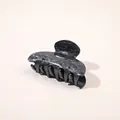 Detailed view of the elegant black and white marble ink texture on an acetic hair claw clip - Gun Black Marble