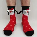 Detail of Christmas magnets socks with 3D hands and festive snowflake knit texture - Red Snowflake Magnetic Hand Holding