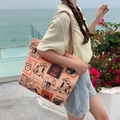 Detail of canvas tote bag featuring artistic cat and coffee illustrations in outdoor setting - Inverted Cat