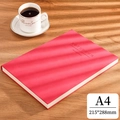 Red A4 faux leather notebook with embossed cover on a wooden desk under window light - Ruled / A4-Red