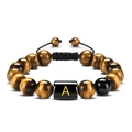 Close-up of 10mm tiger eye beads and black letter A charm on a woven bracelet - Letter A