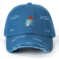 Detail of blue distressed baseball cap with skeleton hand holding rose embroidery - One Size / Blue