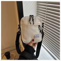 Close-up of beige nylon crossbody bag with Hello Weekend label and black adjustable strap - White