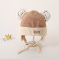 Beige knit baby hat with two white pom-poms, ear flaps and First Day leather patch - 2-6 Years Old / Light Coffee