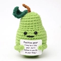 Macro detail of a hand-knitted green positive pear with an encouraging message card - Positive Pear with Card