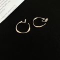 Detailed view of golden twisted hoop earrings with clip-on backs for unpierced ears - Clip-on Style / 3cm / Gold