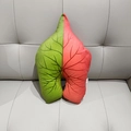 Macro detail of leaf-shaped plush pillow featuring dual-tone fabric and vein patterns - Red & Green Syngonium
