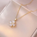 Elegant gold necklace with purple heart-shaped zircon clover pendant on jewelry box - X3341 White Rotating