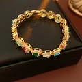 Detailed shot of multi-colored zircon heart bracelets on black leather jewelry box - Multicolor Gemstone Heart Style / Gold Multicolor