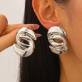 Silver S-shaped twisted geometric metal earring worn by a model in minimalist style - S-Shaped Twisted Abstract Geometric Style / Bright Silver