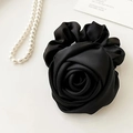 Detail of a black satin rose hair scrunchie with elegant silk texture and pearl accents - Black