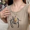 Zen style vintage ceramic long necklace with amber circular pendant shown on model - Amber Brown Oval Pendant Necklace X4378D