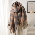 Detailed view of the thick brown and grey plaid scarf with fringes on a mannequin - Earthy Yellow