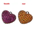 Macro detail of two-tone heart pendants featuring colorful pavé crystals and dark silver plating - Gun Black Rose/Orange Zircon Heart