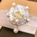 Elegant rotating snowflake brooch with white mother of pearl petals and teardrop pearl - Golden Flower with White Shell