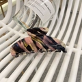 Close-up of a large floral marble acetate hair claw clip with colorful pink and gold swirls - Approx 10.5cm / Black Pink Colorful Stripe