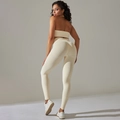 Detail of seamless ribbed beige yoga set featuring high-waisted leggings and sports bra - Beige