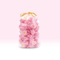 Roze geurparels voor de was in een zakje met madeliefjespatroon op een roze achtergrond - 100 stuks Roze Verpakking