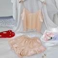 Champagne satin loungewear set with V-neck camisole and ruffled shorts on white fur rug - Champagne