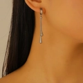 Detailed view of silver water drop tassel earrings worn by a model in a profile shot - Steel Color Stainless Steel Waterdrop Ear Buckle (K1026)