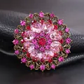 Vintage floral brooch with red and pink crystals in an ornate bronze hollow-out design - Antique Gold, Ruby Red