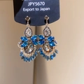 Detailed macro view of luxurious blue teardrop crystal earrings with silver setting - 26# Silver Needle - Blue
