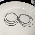 Elegant silver-colored triple layered nesting metal hoop earrings in a minimalist design - Triple-layer Nesting Hoop Style / Silver