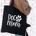 Black canvas tote bag with white Dog Mom lettering and paw print graphic - DOG MOM Paw Print