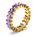 Macro shot of gold eternity ring featuring oval-cut purple zircons in claw settings - Gold + Purple Zirconia