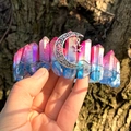 Detailed close-up of handmade pink-blue aura crystal crown with moon and star charms - Purple Blue