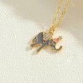 Macro shot of cute grey enamel elephant pendant with crystals on a delicate gold chain - Elephant Pendant (XL2706-6)