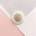Detail of round charm with white pearls and champagne rhinestones on pink and grey background - Silver Round Champagne