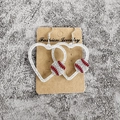 Détail de boucles d'oreilles cœur argentées scintillantes avec motif baseball - Cœur Pailleté Argent Baseball